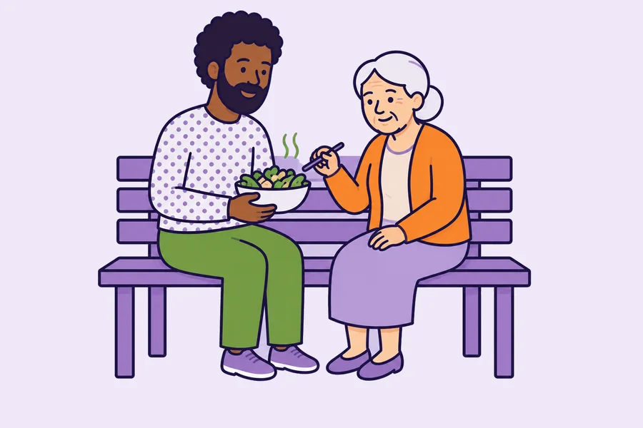 A worker and an older woman on a bench with a bowl of food.
